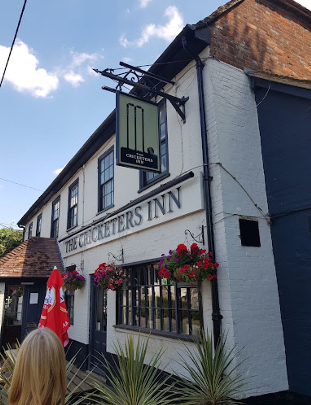 The exterior of the Cricketer's Inn, showing the traditional pub sign