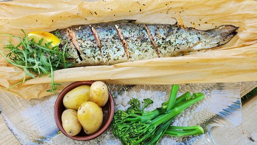 A fish being prepared in a kitchen