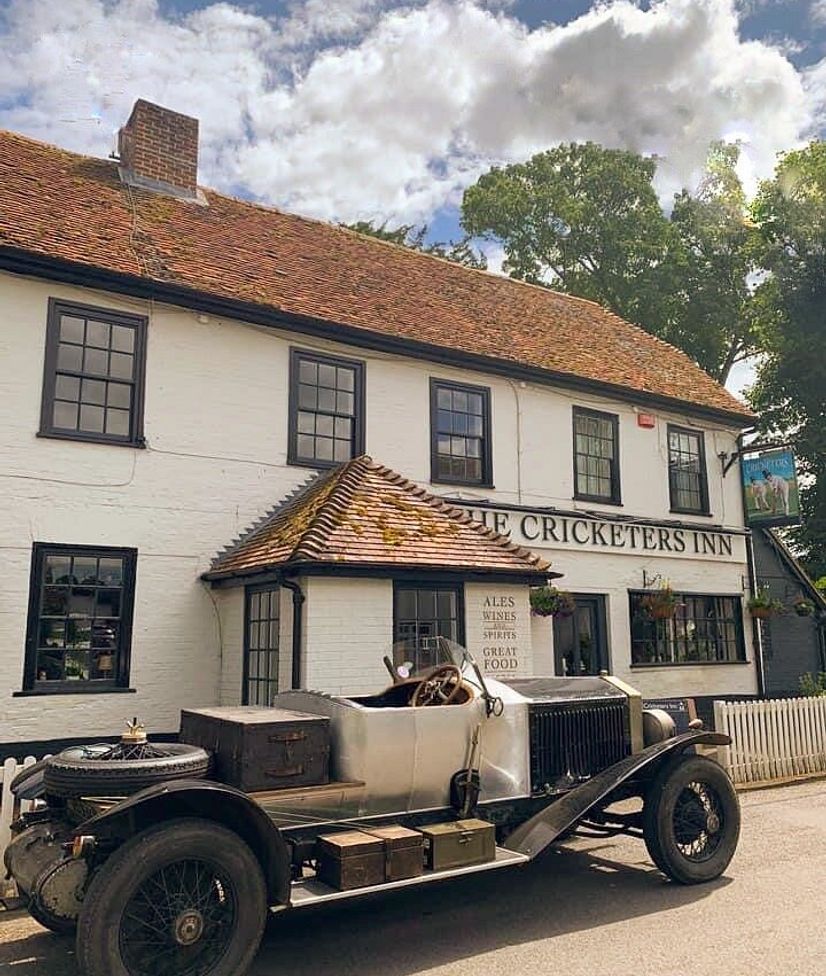 a station wagon parked outside the front door of the cricketer's inn