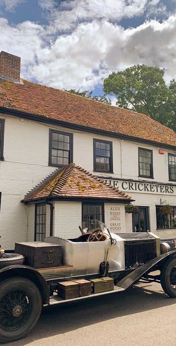 tha station wagon parked outside the front door of the cricketer's inn